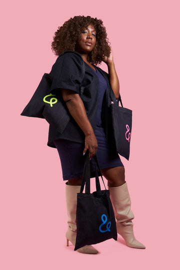 model wearing new tote bag collection with neon colored logos